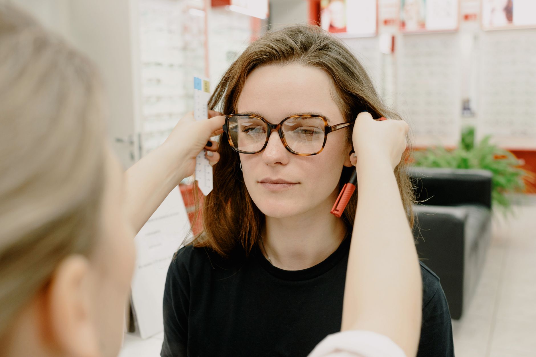 A doctor performing a throat exam to check for white spots on tonsils.