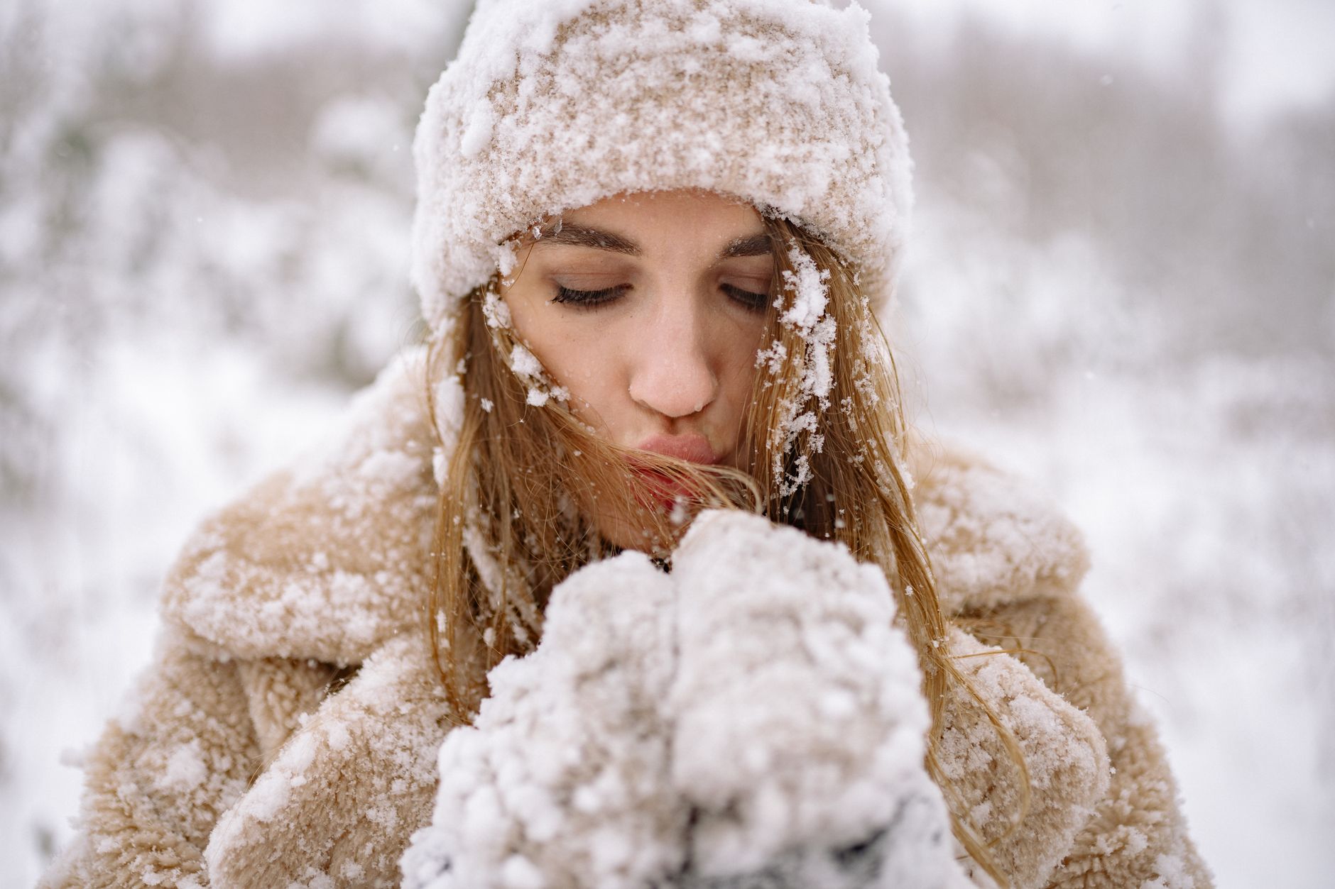 A person applying moisturizer as part of their cold weather skin care routine.