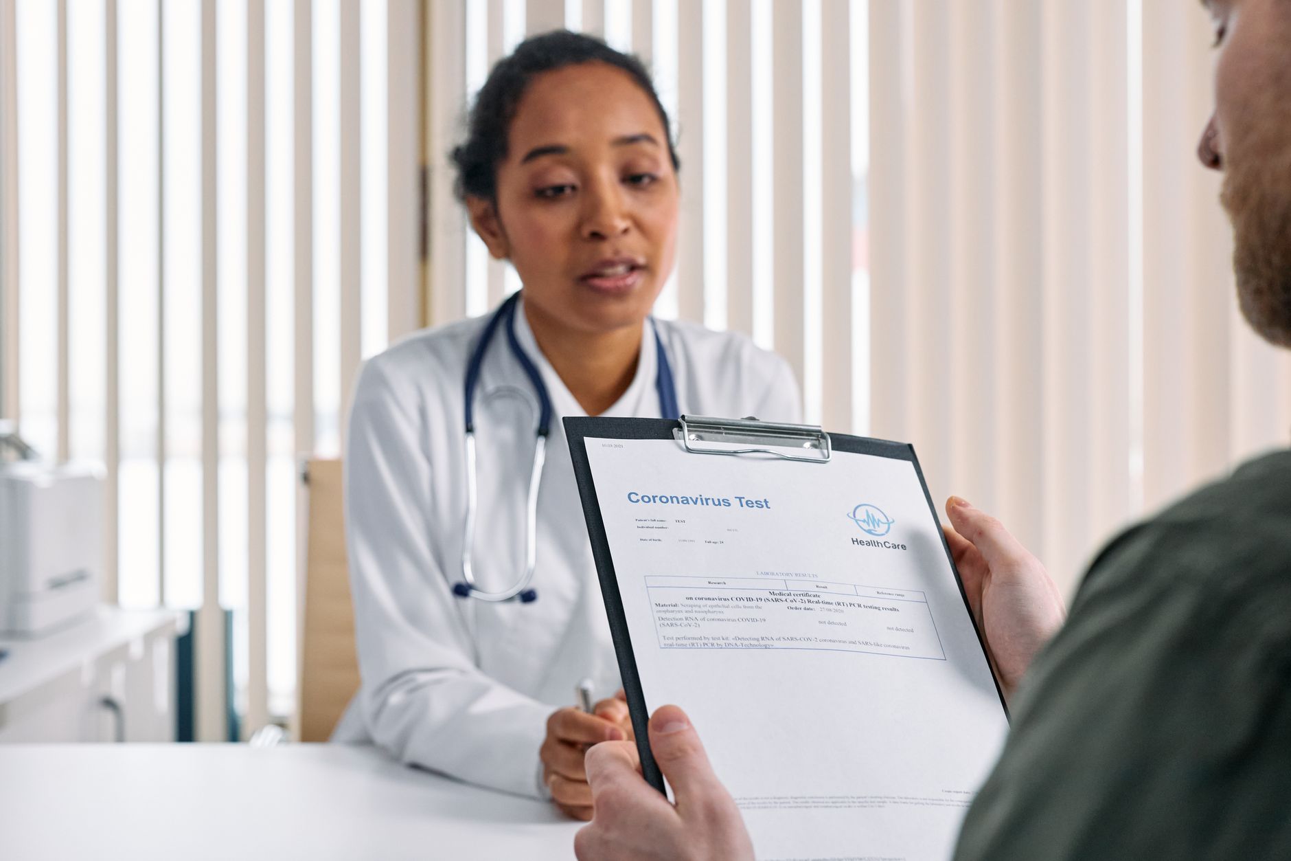 A healthcare professional reviewing A1C test results during a routine medical consultation.