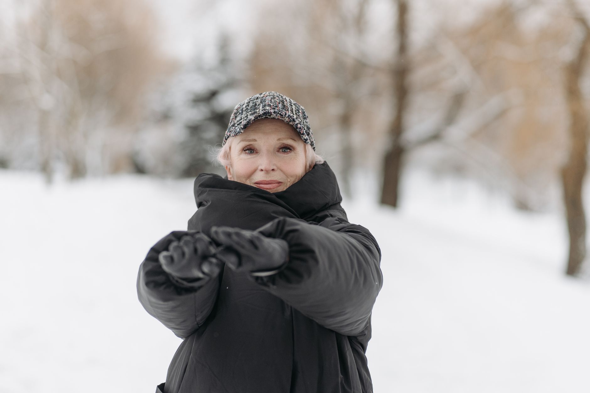 Applying sunscreen for cold weather skin care during a winter day.