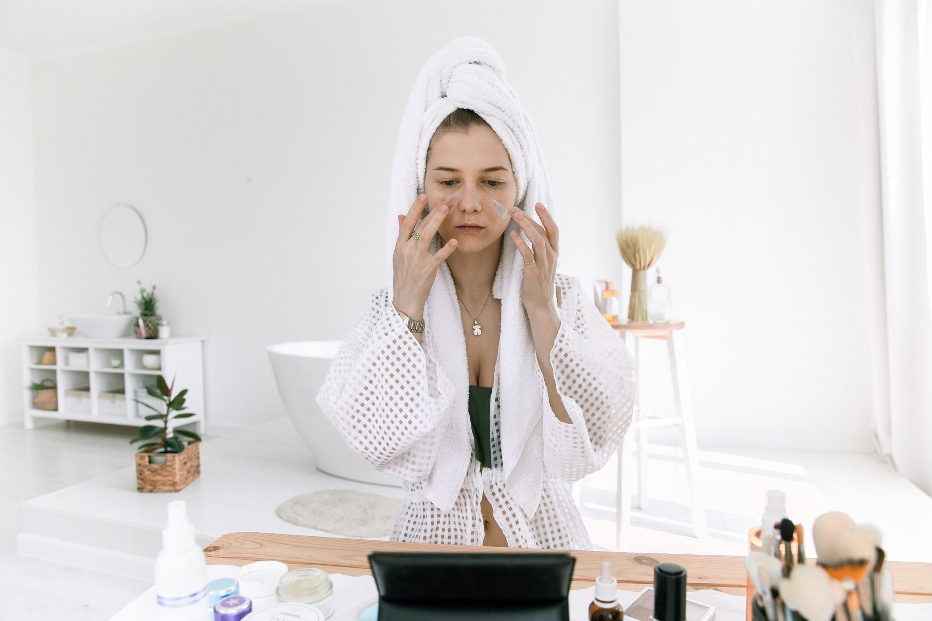 A person using a gentle moisturizer after applying azelaic acid for acne treatment.