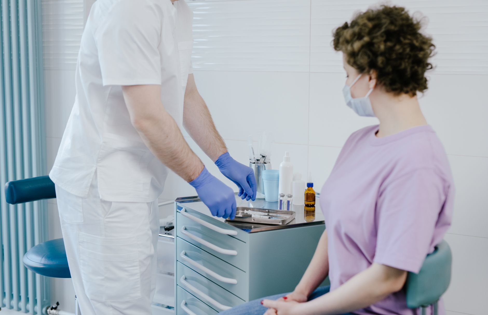A person applying vitamin C serum benefits to their face in a mirror.